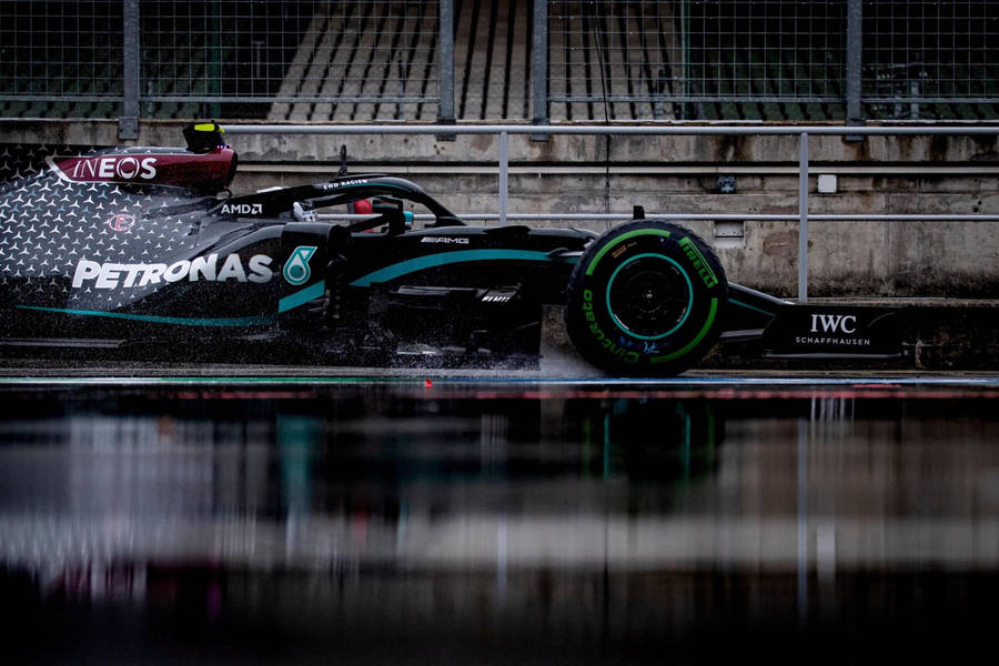 Caption: Mercedes Amg Petronas F1 Racing Car On Track Wallpaper