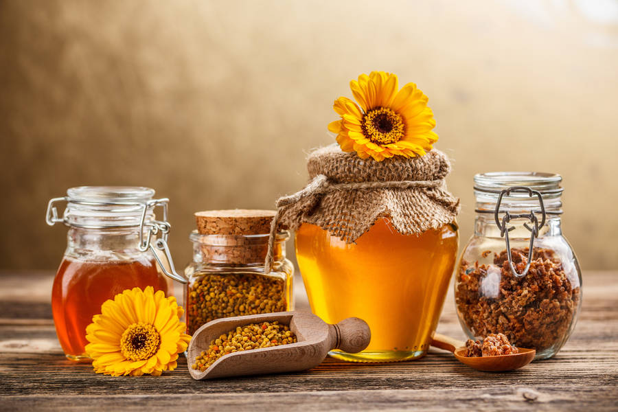 Caption: Natural Honey In Jars With Bee Pollen Wallpaper