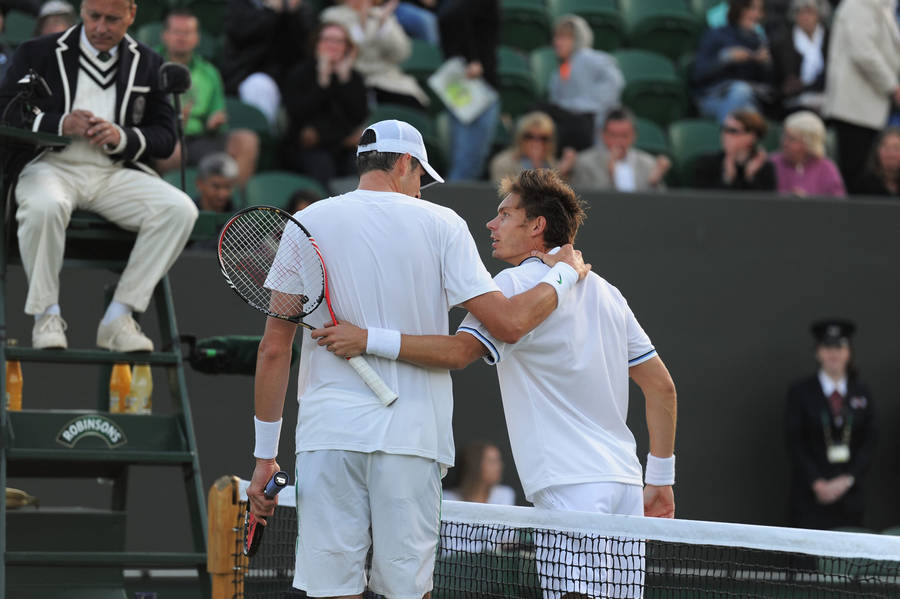 Caption: Nicolas Mahut And John Isner Strategizing On Court Wallpaper