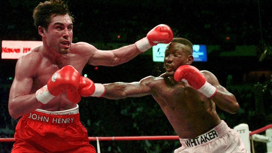 Caption: Pernell Whitaker Masterfully Dodging A Punch In The Ring Wallpaper