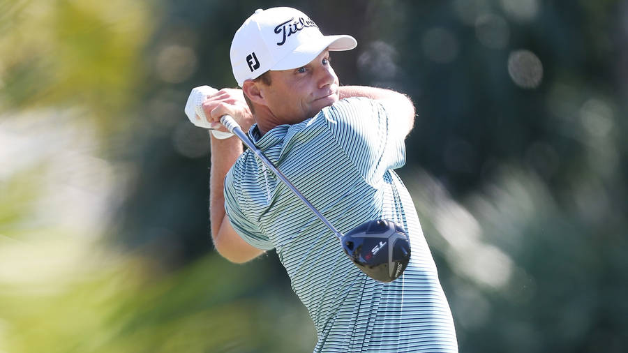 Caption: Prominent Golfer Nick Watney In Mid-swing On Green Wallpaper