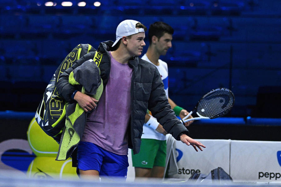 Caption: Rising Star Holger Rune In Mid-action On The Tennis Court Wallpaper