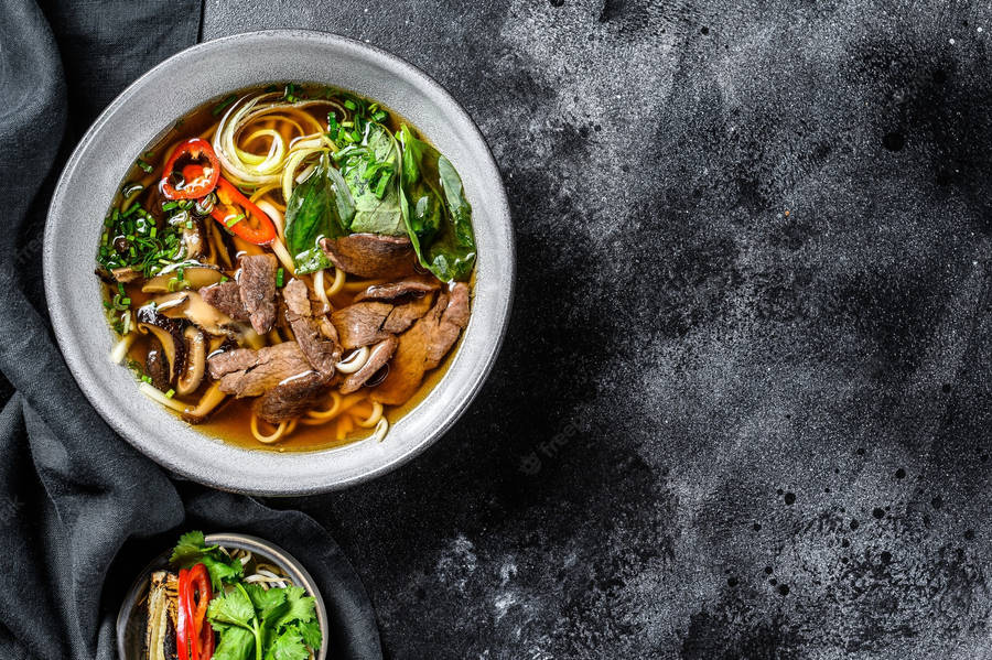 Caption: Savory Pho Soup With Beef And Chili Wallpaper