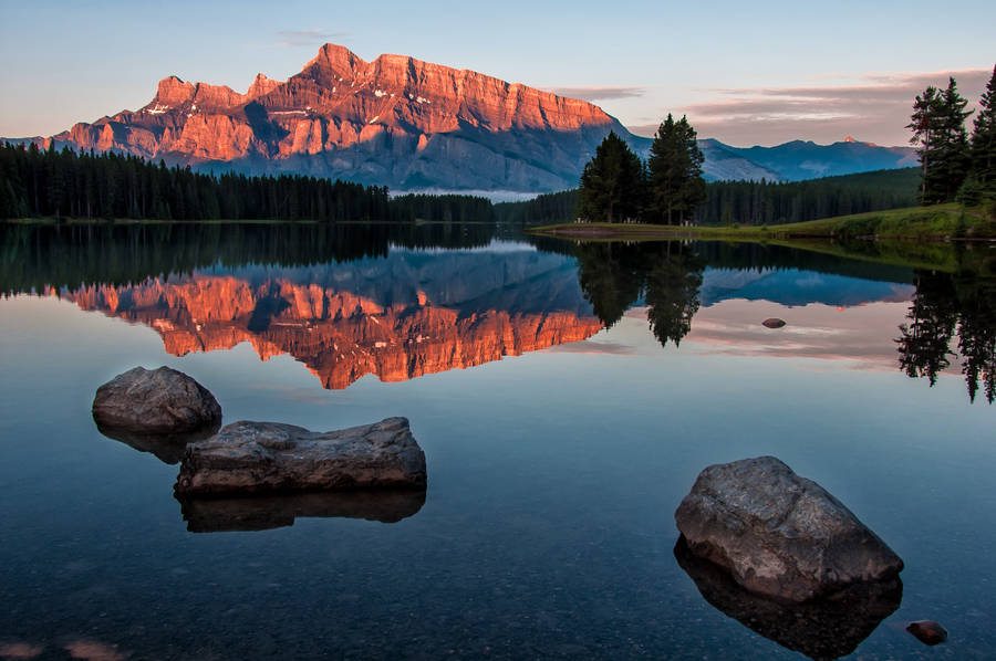 Caption: Serene Forest Lake In Alberta Wallpaper