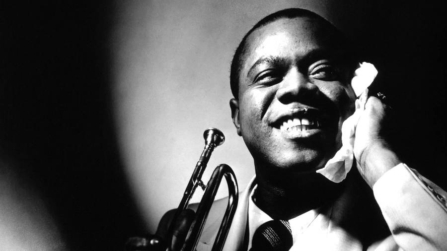 Caption: Smiling Portrait Of Louis Armstrong Wallpaper