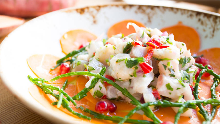 Caption: Spicy Ceviche Garnished With Herbs And Chilies Wallpaper