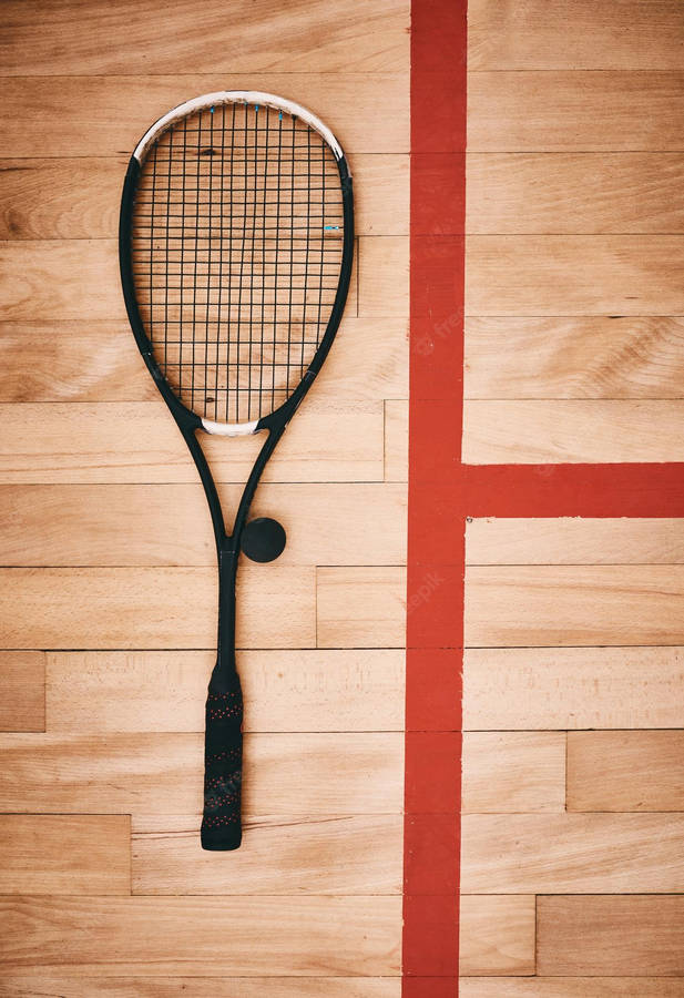 Caption: Squash Essentials - A Racket And Ball Beside The Red Line Wallpaper