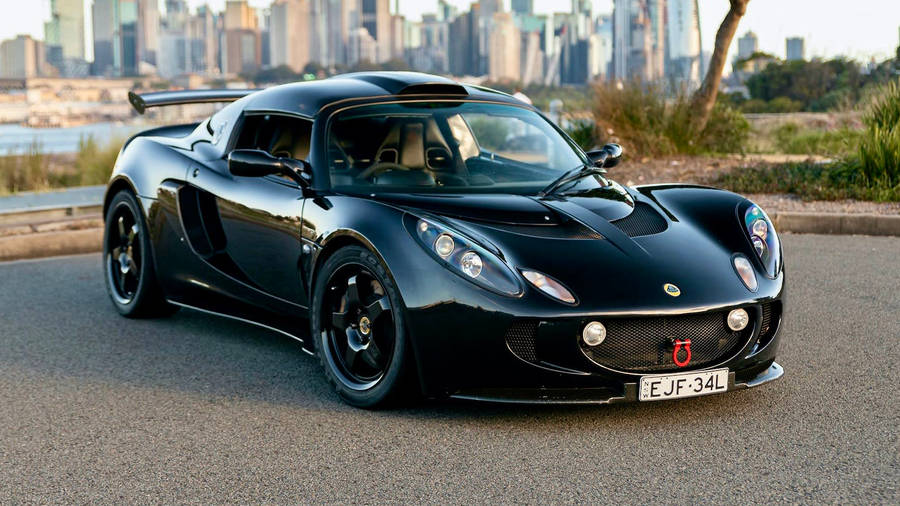 Caption: Striking Black Lotus Exige Dominating The Road Wallpaper