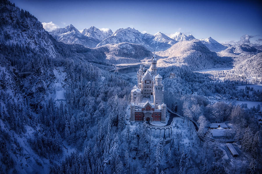 Caption: The Iconic Neuschwanstein Castle Encapsulated In Winter Elegance Wallpaper