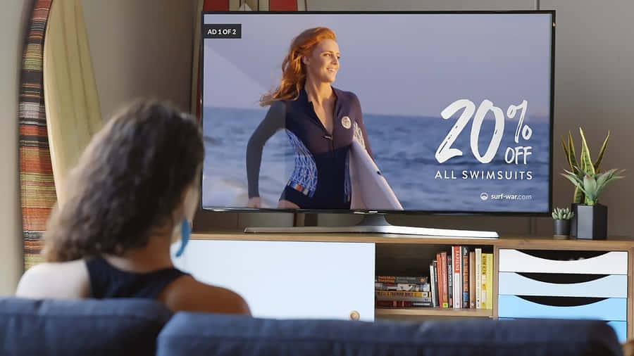 Caption: Woman Engrossed In A Swimsuit Commercial Wallpaper