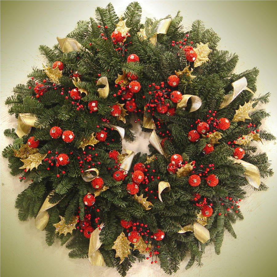 Captivating Christmas Wreath Adorned With Gold Ribbons Wallpaper