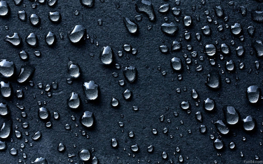 Captivating Close-up Of Dark Water Droplets Wallpaper