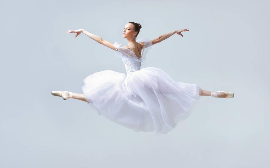 Captivating Leap Of Grace: Ballerina Mid-air Wallpaper