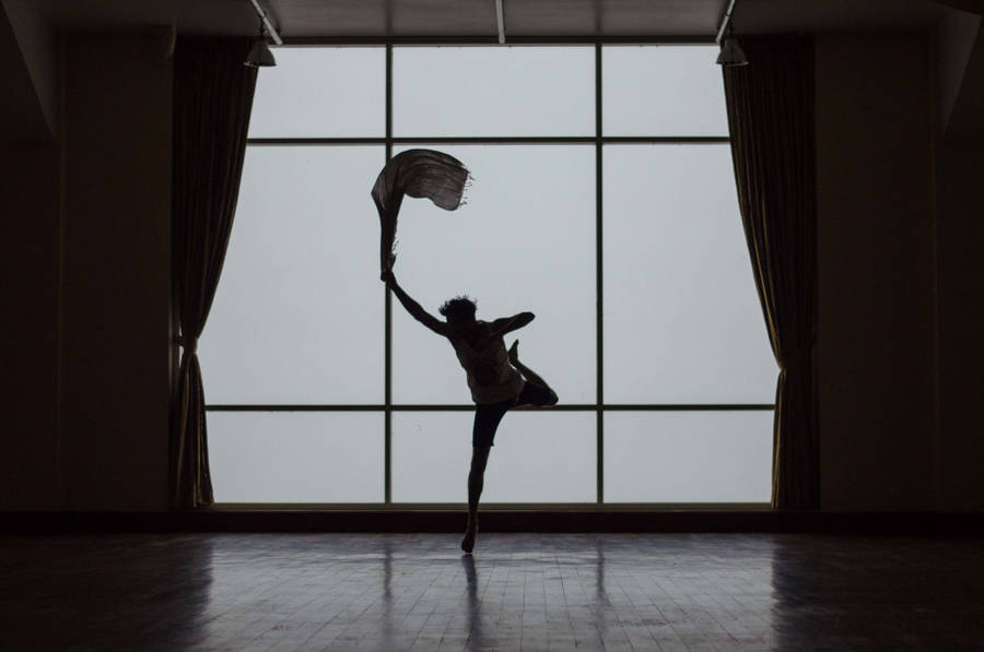 Captivating Silhouette Of A Man Embracing His Dance Pose Wallpaper