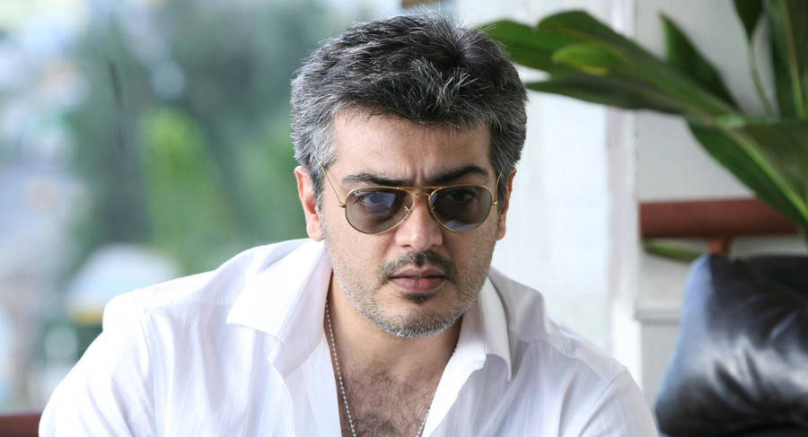 Captivating Stare: Ajith Kumar In A White Polo Hd Photo Wallpaper