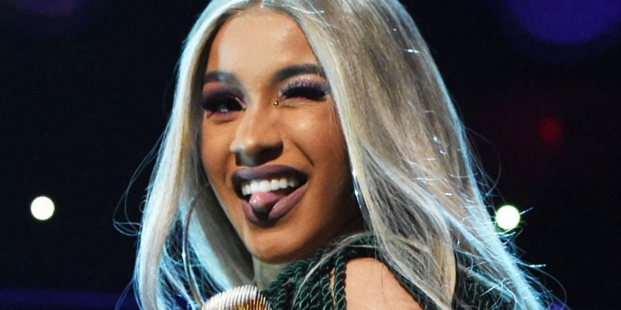 Cardi B Winking With Tongue Out Wallpaper