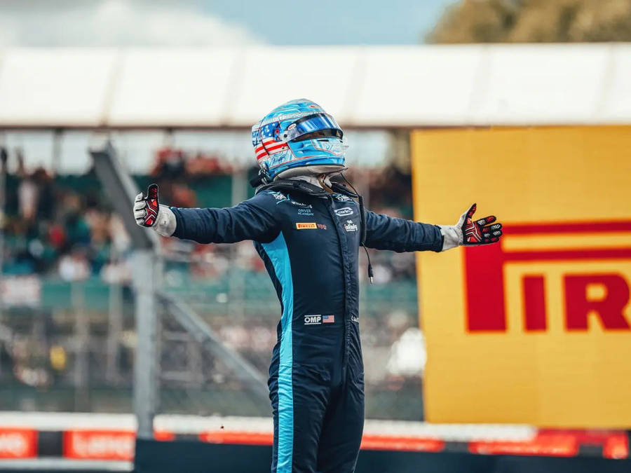 Carlos Sainz Jr. Embracing Victory With Open Arms. Wallpaper