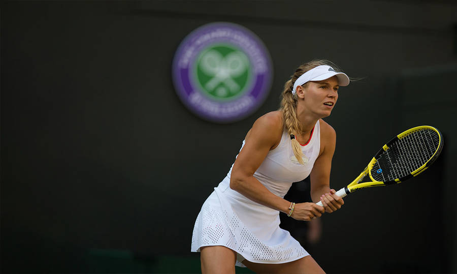 Caroline Wozniacki With Yellow Tennis Racket Wallpaper