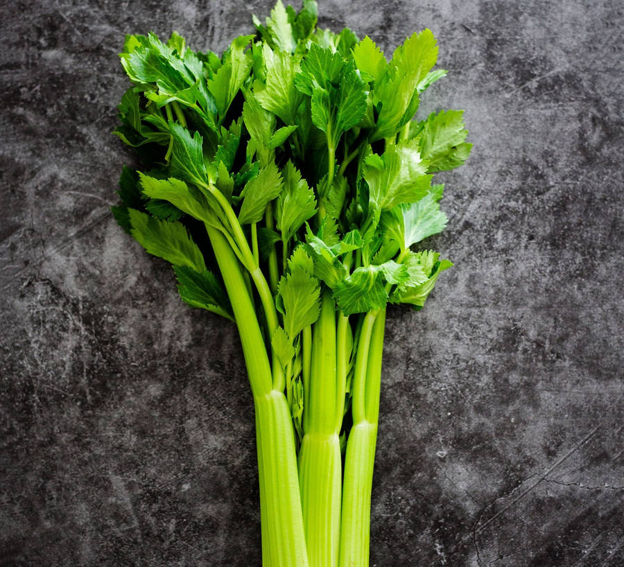 Celery Leaves On Granite Surface Wallpaper