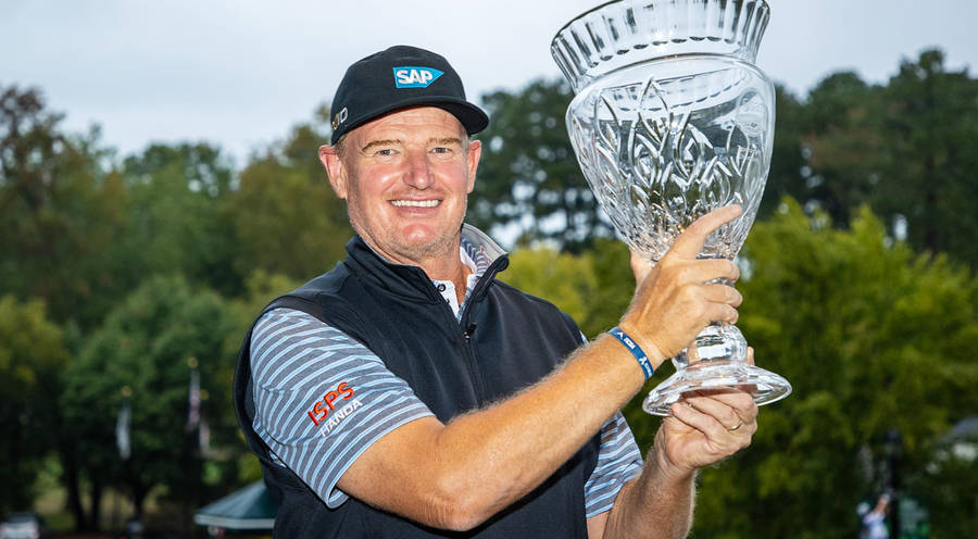 Champion Golfer Ernie Els Holding A Glass Trophy Wallpaper