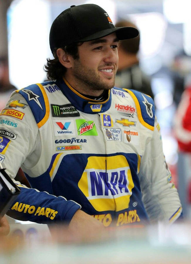 Chase Elliott Triumphantly Standing Before A Blurry Crowd Wallpaper