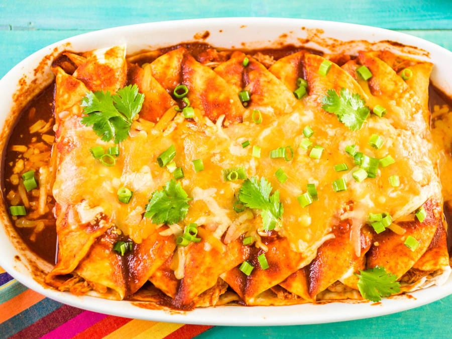 Cheesy And Savory Tray Of Enchiladas Wallpaper