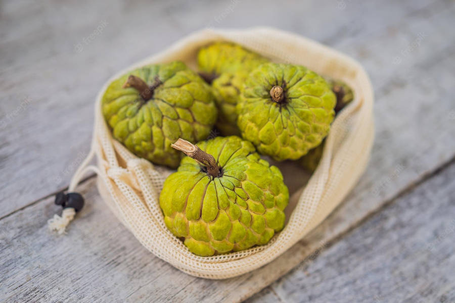 Cherimoya Fruit In Cute String Bag Wallpaper