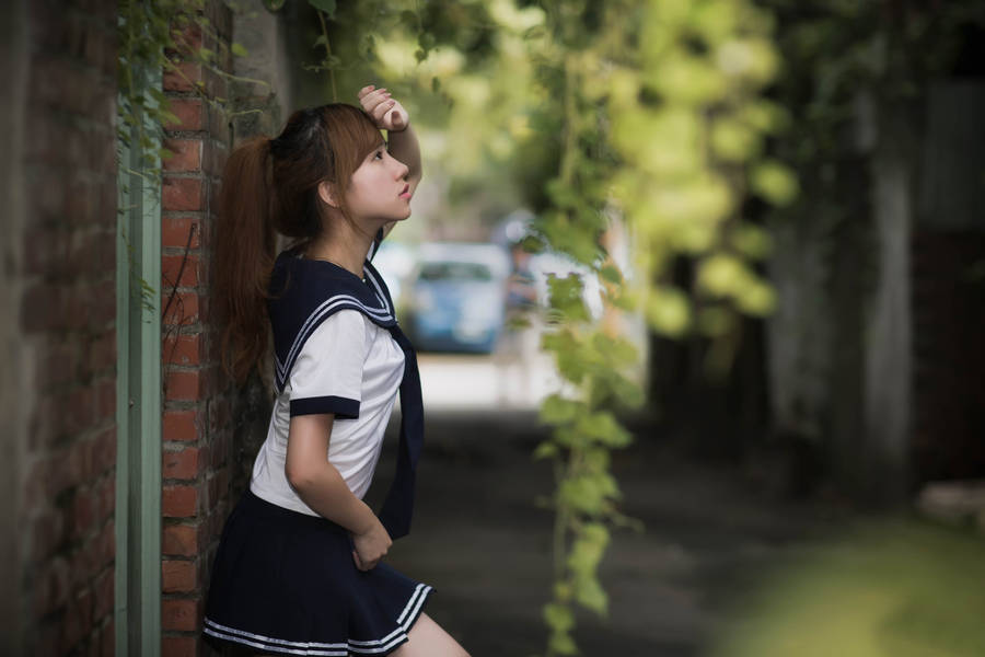 Chinese Woman Posing On Wall Wallpaper