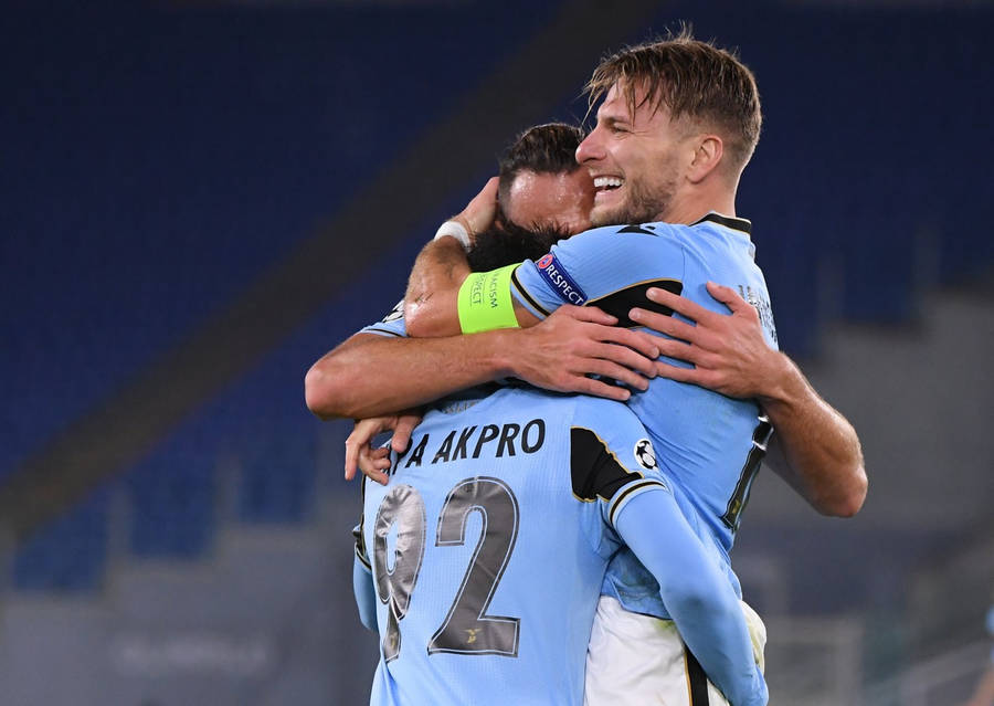 Ciro Immobile Hugging His Teammates Wallpaper