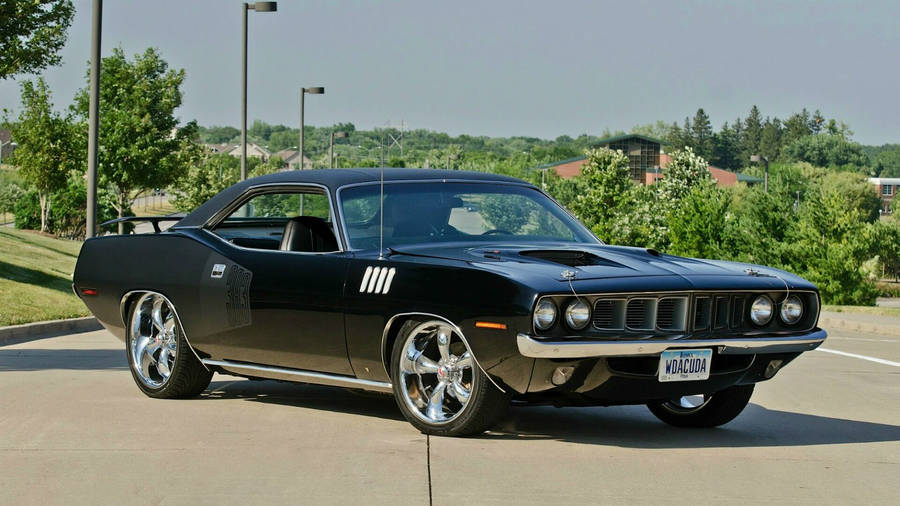 Classic Black 1974 Plymouth Barracuda On The Street Wallpaper