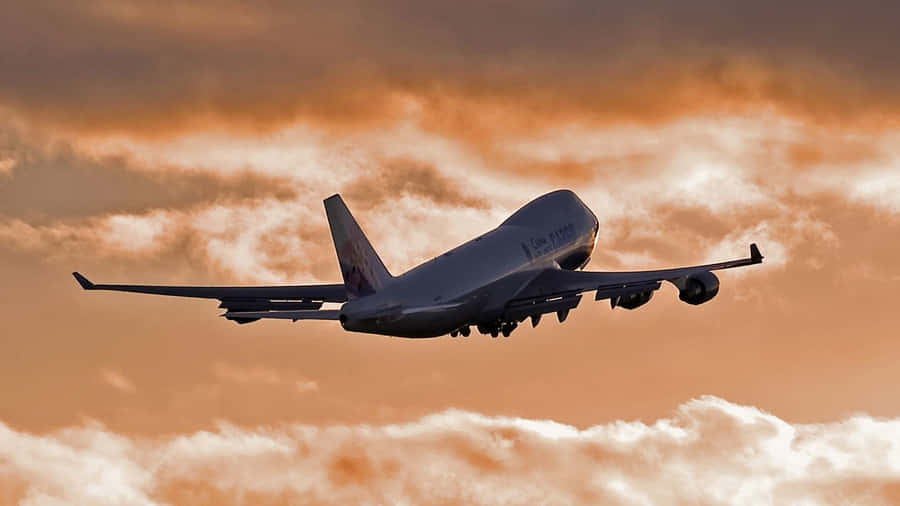 “climb Aboard A Classic: A Boeing 747 Airliner In Flight” Wallpaper