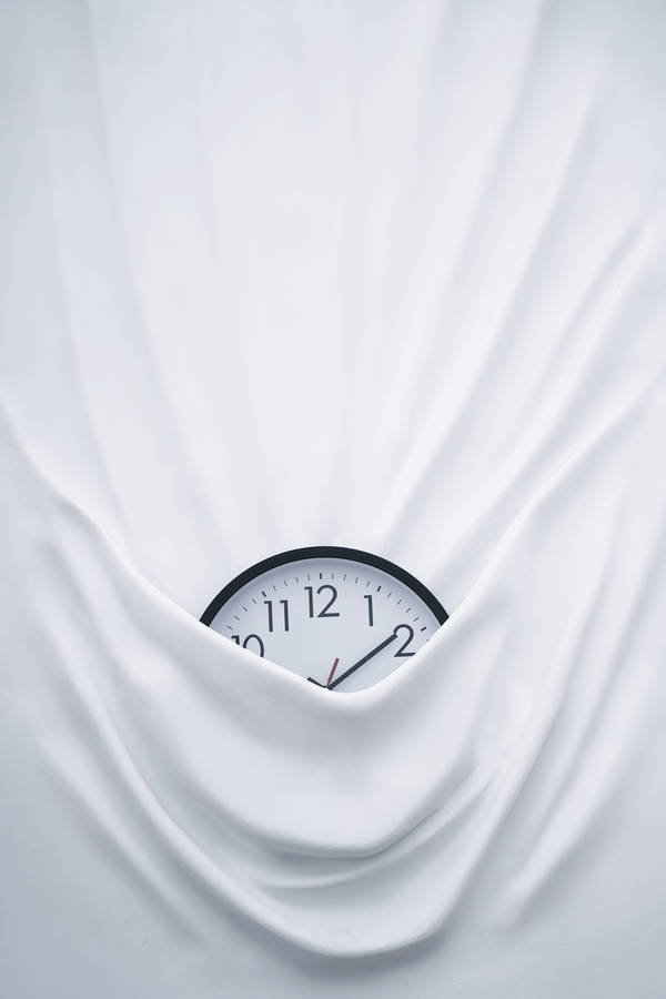 Clock On Bed Sheets Wallpaper