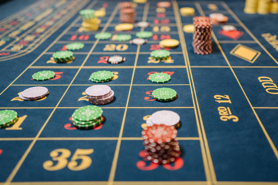 Close-up Photo Of Chip Bets On Blue Table Baccarat Wallpaper