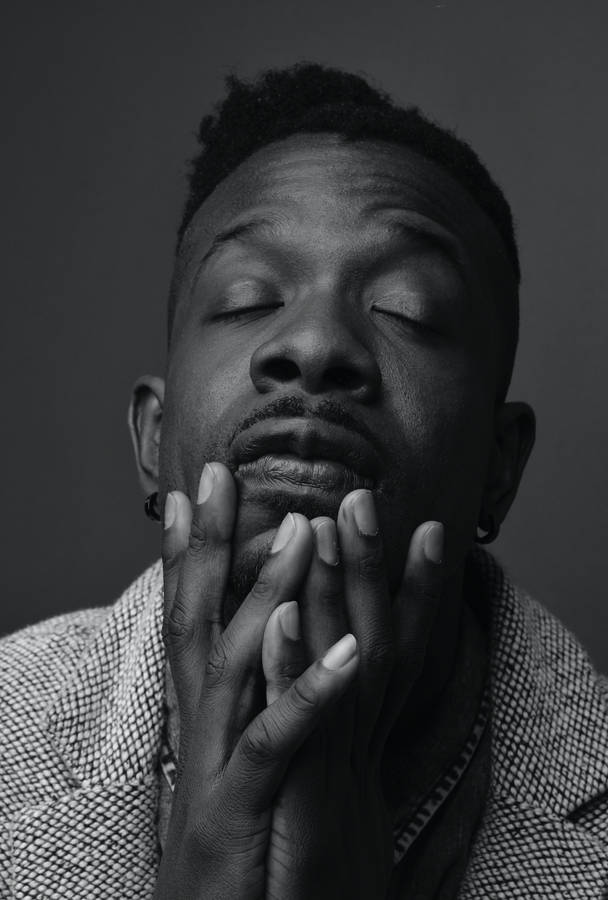 Close-up Portrait Of A Resilient Black Man Wallpaper