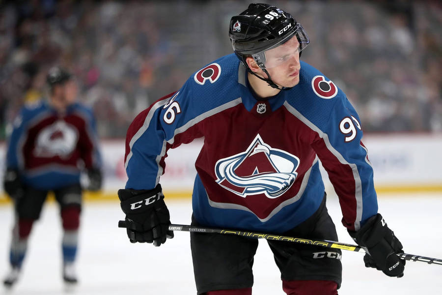 Close Up View Of Mikko Rantanen Looking To The Left While Holding Hockey Stick Wallpaper