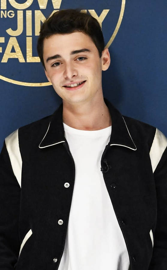 Closeup Noah Schnapp Against Wall Wallpaper