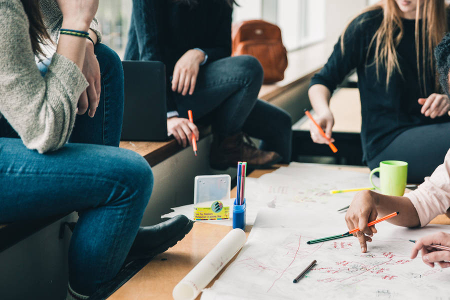 College Students Engaged In A Group Study Session Wallpaper