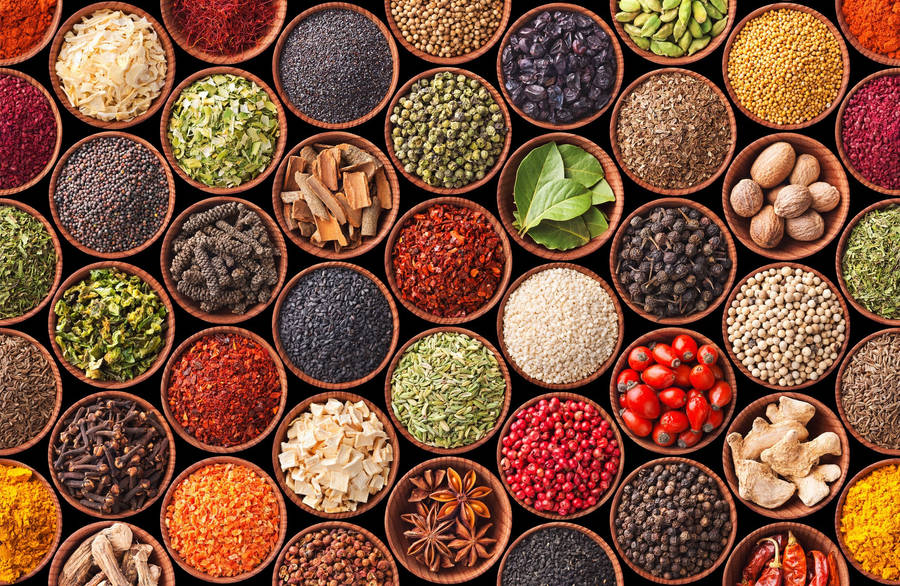 Colorful Spectrum Of Spices And Herbs In Bowls Wallpaper