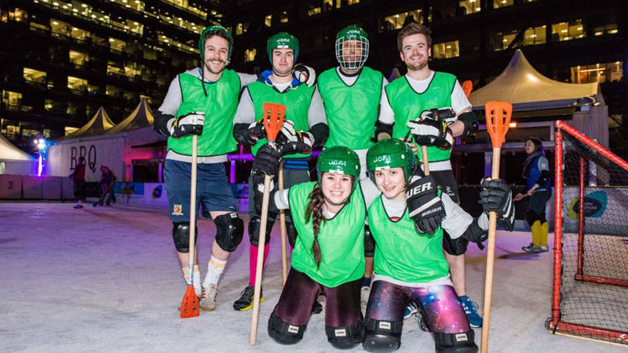 Competitive Broomball Teams In Action Wallpaper