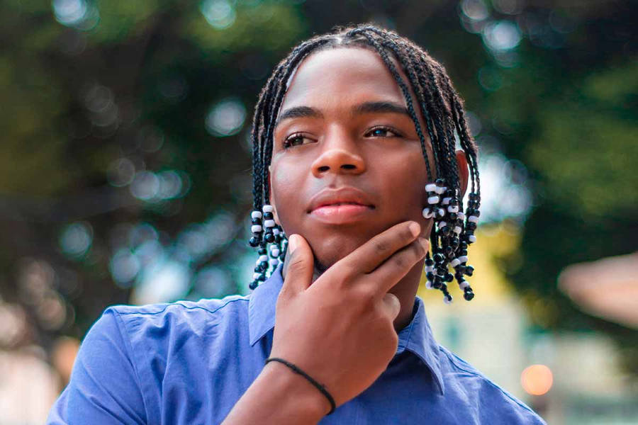 Confident And Handsome Black Man Flaunting His Dreadlocks Wallpaper