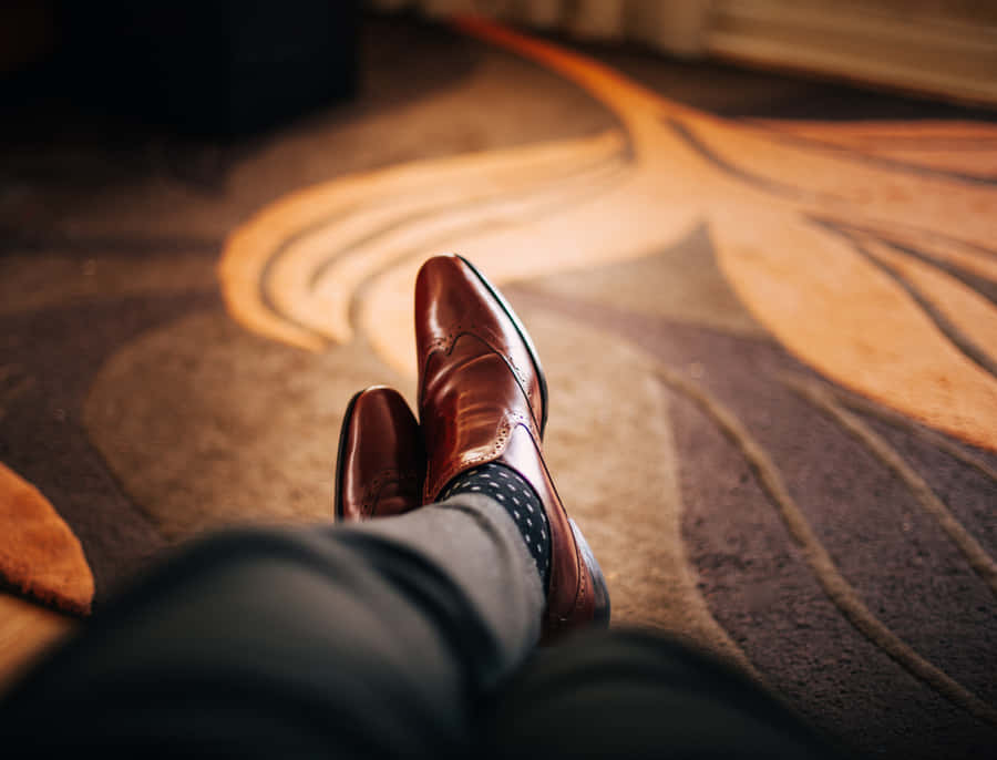 Contemporary Male Feet In Brown Leather Shoes. Wallpaper