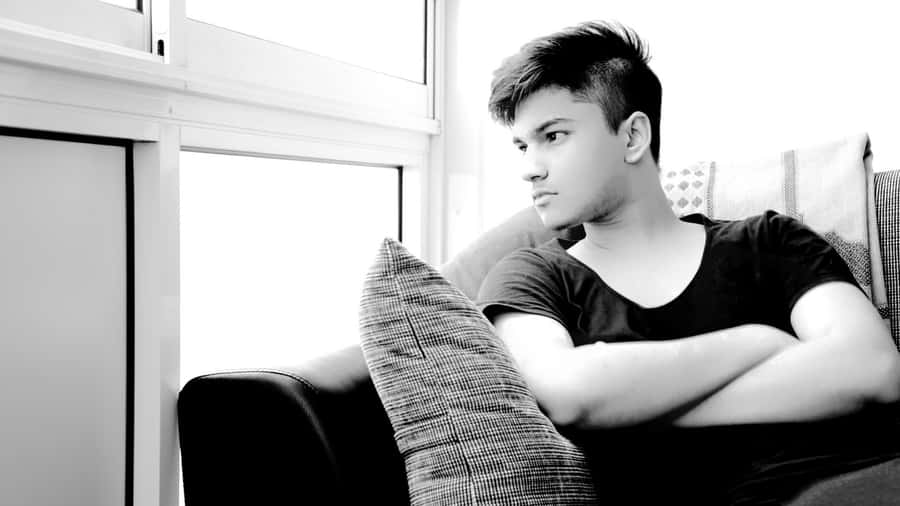 Cool Sad Boy With Crossed Arms Wallpaper