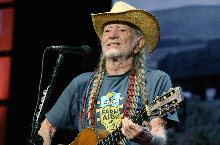 Country Singer Willie Nelson With Long Braided Hair Wallpaper