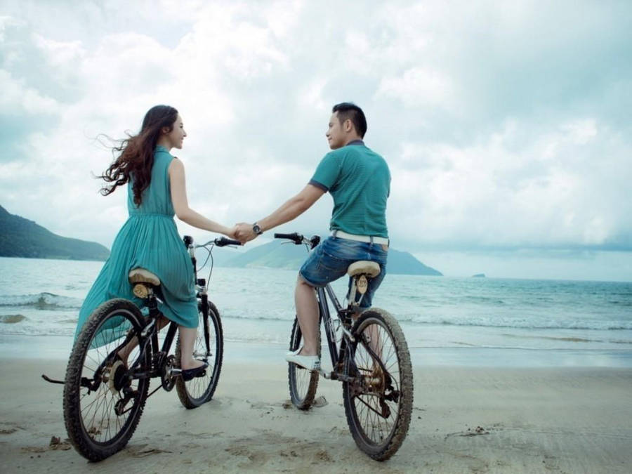 Couple Doing Bike Ride Wallpaper