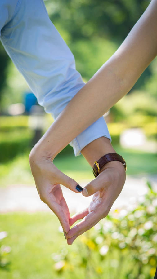 Couple Making Finger Heart Wallpaper