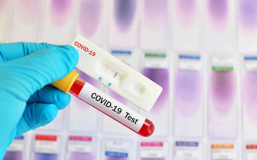 Crucial Covid-19 Test Kit With Red Vial Wallpaper