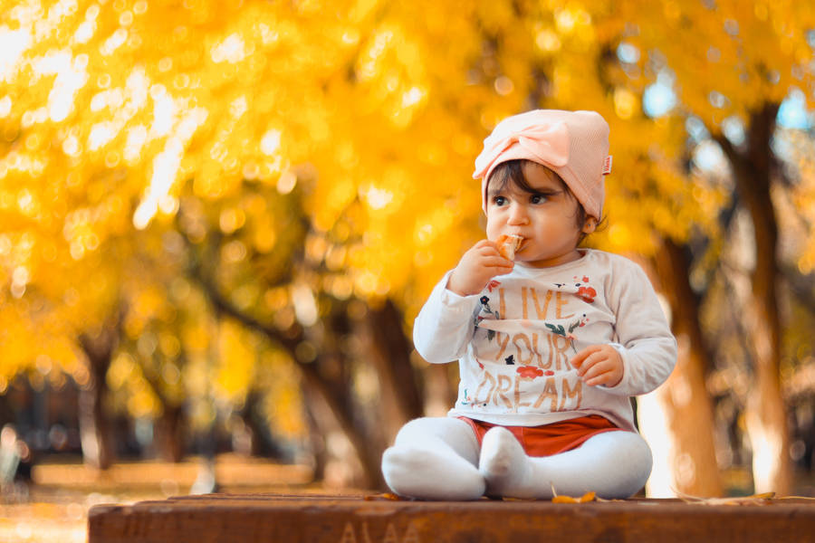 Cute Autumn Baby Sucking Taffy Wallpaper