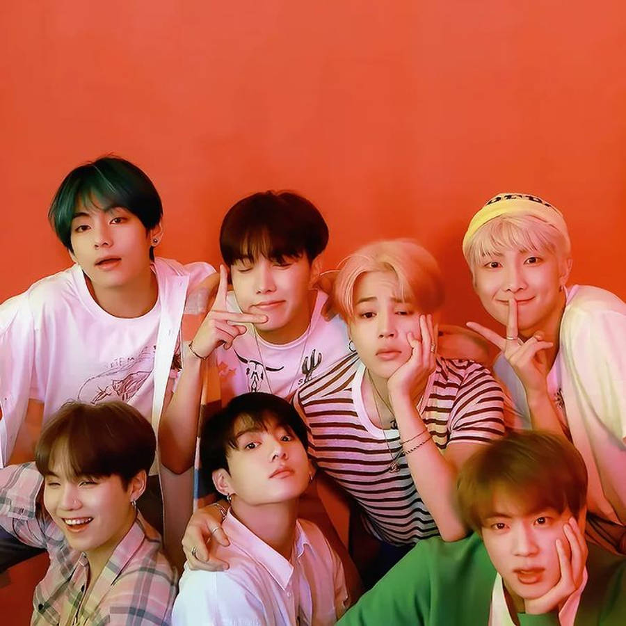 Cute Bts Group On Orange Backdrop Wallpaper