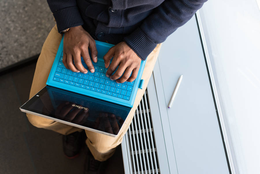 Cute Laptop On A Wooden Desk Wallpaper