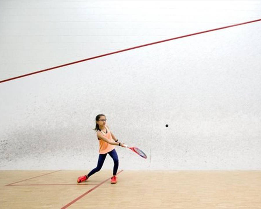 Cute Little Girl Playing Squash Wallpaper